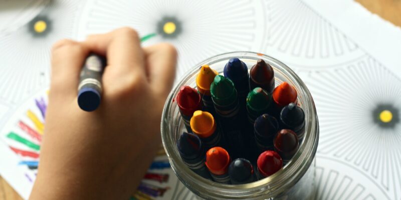 Person coloring art with crayons